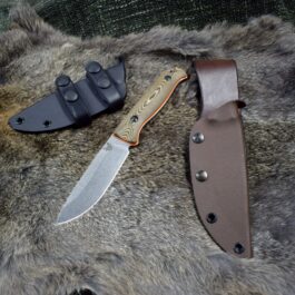 A Benchmade Saddle Mountain Skinner Kydex Sheath laying on top of a fur rug.