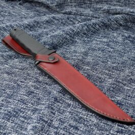 a Vertical Leather Sheath for the SOG Tigershark on a blue cloth.