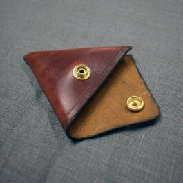 A brown leather Handmade Leather Coin Pouch with two brass studs.