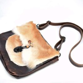 A small Eastern legend Satchel with a furry animal on it.