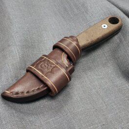 A Leather Scout Sheath for the Esee Izula on a gray cloth.