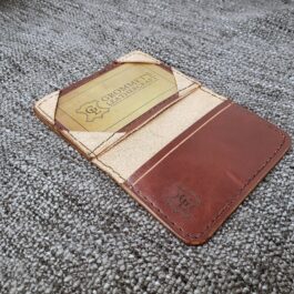 A Minimalist Front Pocket Wallet sitting on top of a gray carpet.