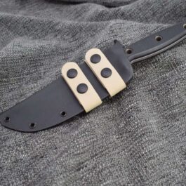 a knife that is laying on a cloth.