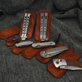 a group of knives and a pair of scissors on a couch.