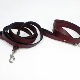 A pair of Handmade Leather Leashes on a white background.