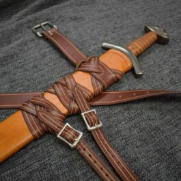 a leather sword with a Custom Wood Core Scabbard on a gray background.