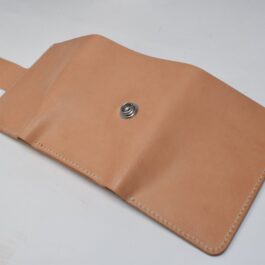 A tan leather Tri Fold Wallet with a button on it.