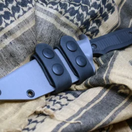 a Scout Style Kydex Sheath For The Benchmade Nimravus that is laying on a blanket.