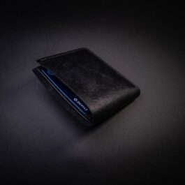 A Custom Handmade Bifold Leather Wallet sitting on top of a table.