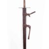A metal sculpture of a sword with a Custom Wood Core Scabbard on a white background.