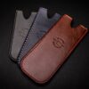 Three different colors of Handmade Leather Pocket Slip on a black surface.