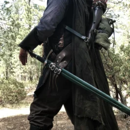 A man wearing the Ranger Baldric holding a bow and arrow.