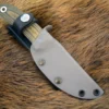 A close up of the Kydex Sheath for the Benchmade Pardue Hunter on a furry surface.