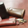A pair of glasses and a Handmade Leather Glasses Case sitting on a table.