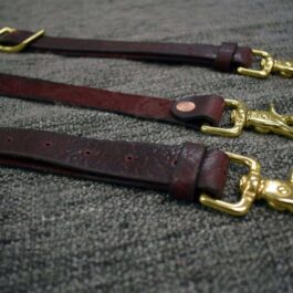 A pair of Bison Leather Suspenders with brass hardware.