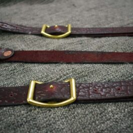 a pair of Bison Leather Suspenders with gold buckles.
