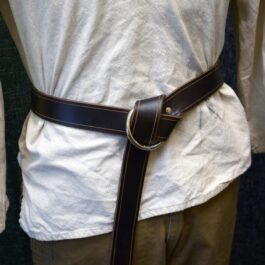 A man wearing a white shirt and brown pants, cinched together with a Ring Belt.
