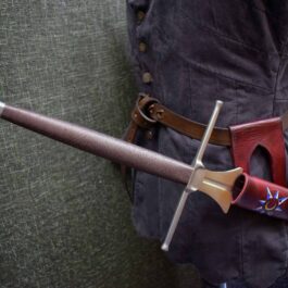 A person holding a Handmade Leather Sword Hanger with a red handle.