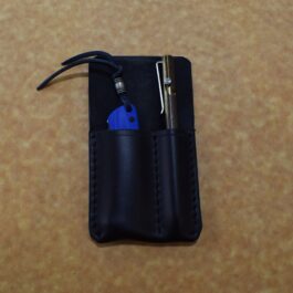 A black Handmade Leather 2 Slot Pocket Organizer with a blue pocket knife inside.