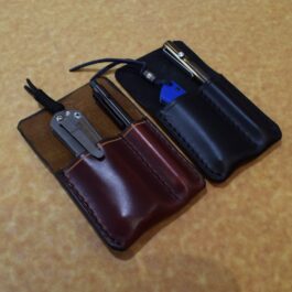 A Handmade Leather 2 Slot Pocket Organizer with a pocket knife and a pocket knife in it.