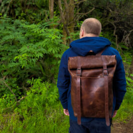 A man with a Bison Leather Roll Top Rucksack on his back.