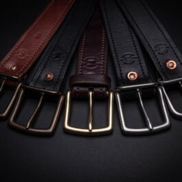 A row of Heavy Duty Belts with metal buckles on them.
