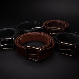 a group of four Heavy Duty Belts sitting on top of a table.