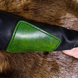 A person wearing Mirkwood Archers Vambrace, a green and black leather glove.