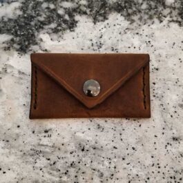 A brown leather Business Card Wallet with a button on it.