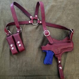 a red leather Shoulder Holster For Full Size 1911 and a blue plastic gun.