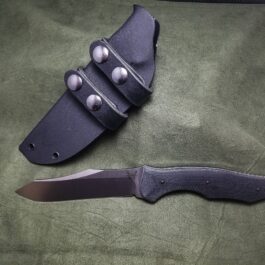 a Kydex Sheath for the Benchmade Fixed Contego on a green cloth.