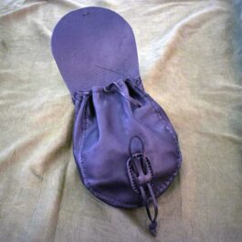 A large sporran belt pouch sitting on top of a bed.