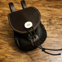 a black leather Small Sporran Belt Pouch with a white button on it.