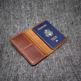 A Handmade Leather Passport Wallet with a US passport sticking out of it.