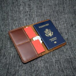 A Handmade Leather Passport Wallet sitting on top of a couch.