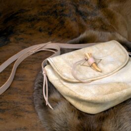 a Brain Tan Frontiersman Saddlebag sitting on top of a fur covered floor.
