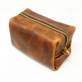 A Leather Dopp Kit/ Toiletry Bag on a white background.