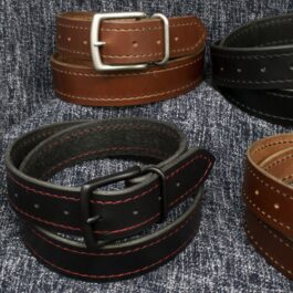 A group of three Heavy Duty Belts sitting on top of a couch.