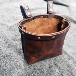 a Bison leather Dump Bag with two metal handles.