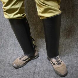 A close up of a person's legs wearing Handmade Leather Greaves.