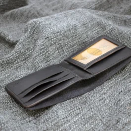 An ID Slot leather Bifold Wallet with a credit card sticking out of it.