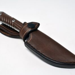 A Chris Reeve Nyala knife with a Vertical Leather Sheath on a white surface.