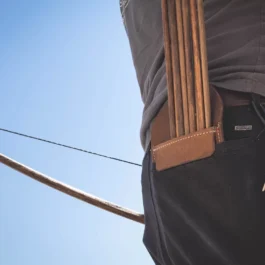 A man is holding a Leather Pocket Quiver.