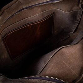 A Waxed Canvas Briefcase Satchel with a brown leather handle.