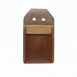 A brown Leather Pocket Quiver with two buttons on it.