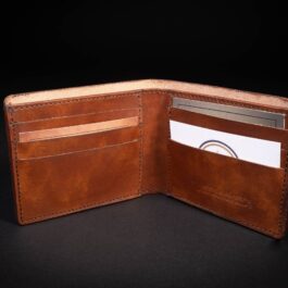 A Custom Italian Leather Bifold Wallet with a credit card inside of it.