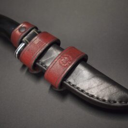 a Handmade Leather Sheath for the Buck 119 with a black handle.
