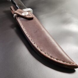 a brown Handmade Leather Sheath for the Buck 119 with a black handle.
