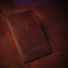 An ID Slot leather Bifold Wallet sitting on top of a table.
