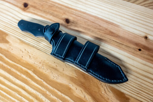 A Leather Sheath for the Benchmade Fixed Contego on a Wooden Table.